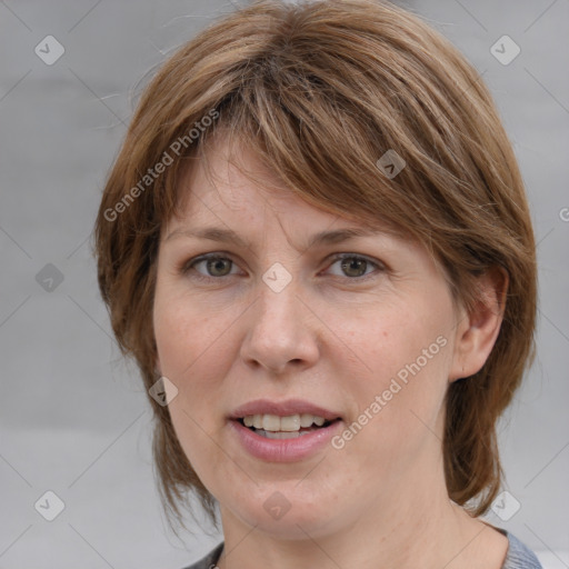 Joyful white adult female with medium  brown hair and grey eyes