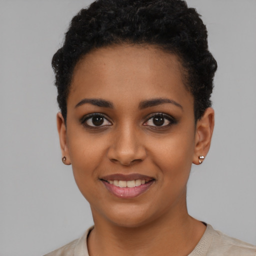 Joyful latino young-adult female with short  black hair and brown eyes