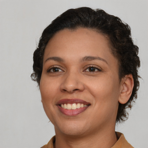 Joyful latino young-adult female with short  brown hair and brown eyes