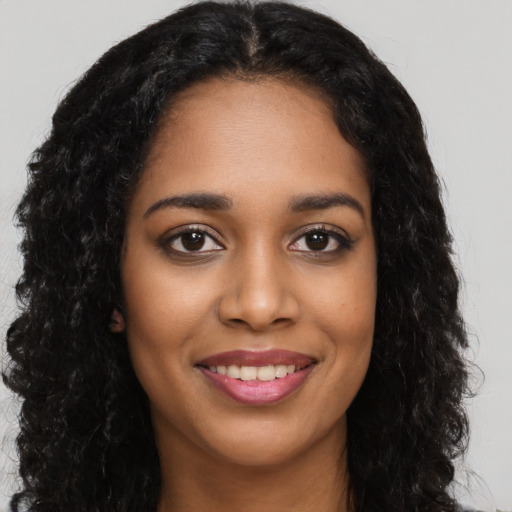 Joyful latino young-adult female with long  black hair and brown eyes