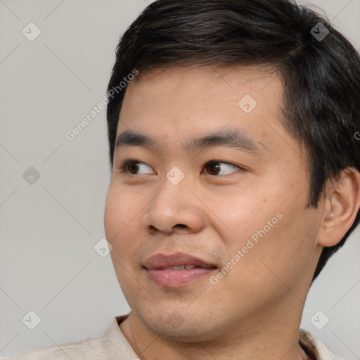 Joyful asian young-adult male with short  black hair and brown eyes