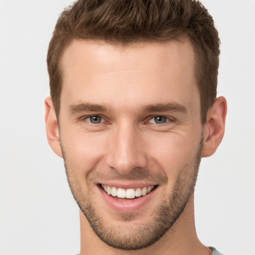 Joyful white young-adult male with short  brown hair and brown eyes