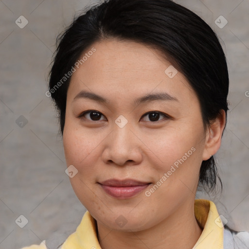 Joyful asian adult female with medium  brown hair and brown eyes