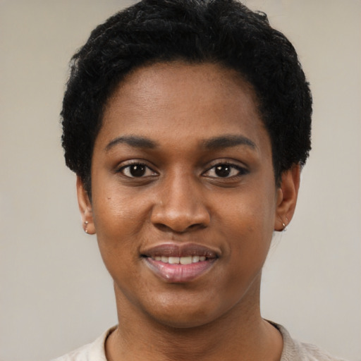Joyful black young-adult female with short  black hair and brown eyes