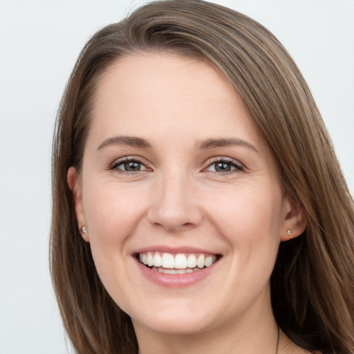 Joyful white young-adult female with long  brown hair and grey eyes