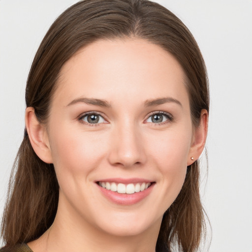 Joyful white young-adult female with medium  brown hair and grey eyes