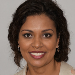 Joyful black young-adult female with medium  brown hair and brown eyes