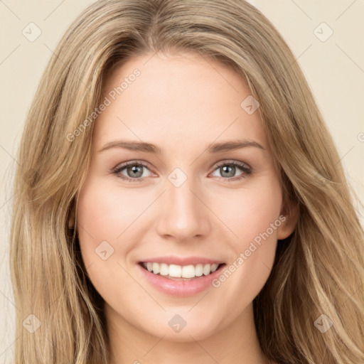 Joyful white young-adult female with long  brown hair and green eyes