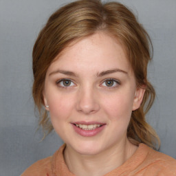 Joyful white young-adult female with medium  brown hair and blue eyes