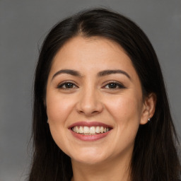 Joyful white young-adult female with long  brown hair and brown eyes