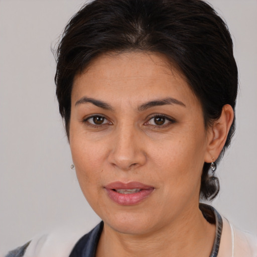 Joyful white adult female with medium  brown hair and brown eyes