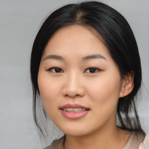 Joyful asian young-adult female with medium  black hair and brown eyes