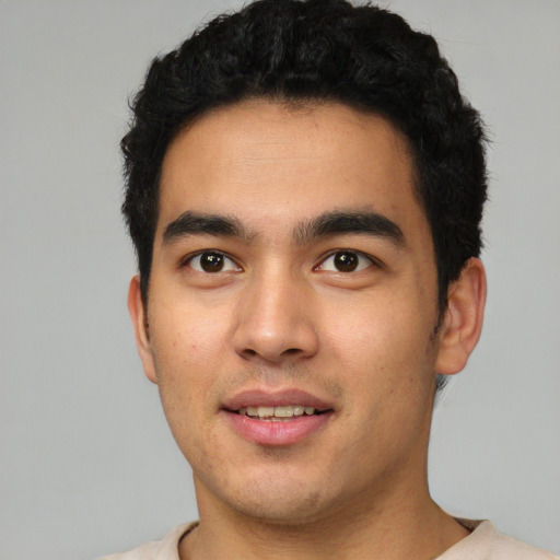 Joyful latino young-adult male with short  black hair and brown eyes