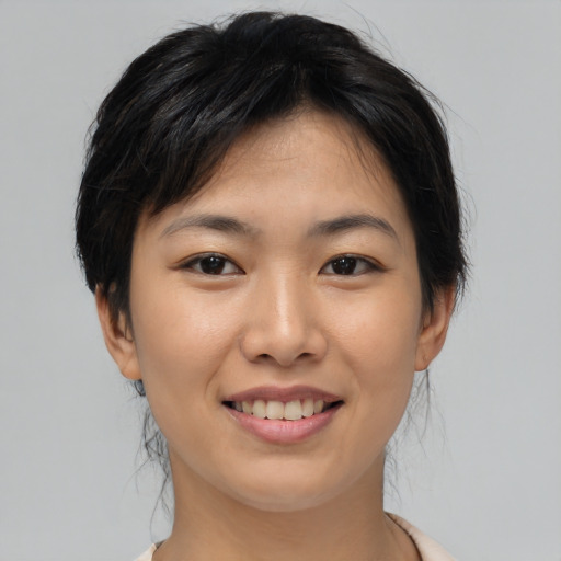 Joyful asian young-adult female with medium  brown hair and brown eyes