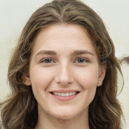 Joyful white young-adult female with long  brown hair and green eyes