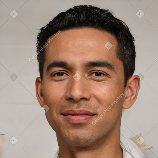 Joyful white young-adult male with short  black hair and brown eyes