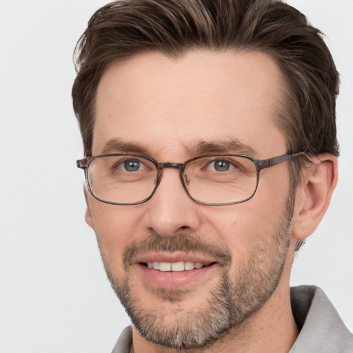 Joyful white adult male with short  brown hair and grey eyes