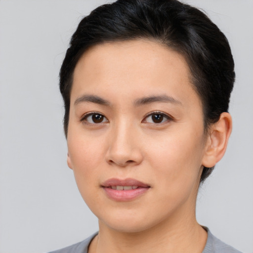 Joyful asian young-adult female with short  brown hair and brown eyes