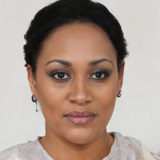 Joyful black young-adult female with short  black hair and brown eyes