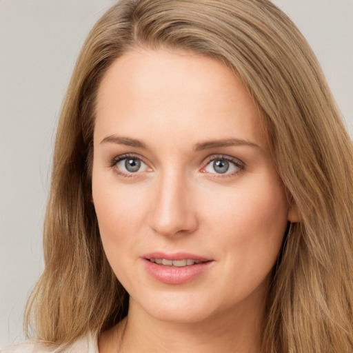 Joyful white young-adult female with long  brown hair and grey eyes