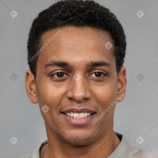 Joyful black young-adult male with short  black hair and brown eyes