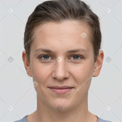 Joyful white young-adult female with short  brown hair and grey eyes