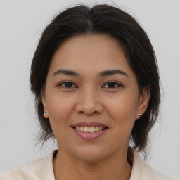 Joyful asian young-adult female with medium  brown hair and brown eyes