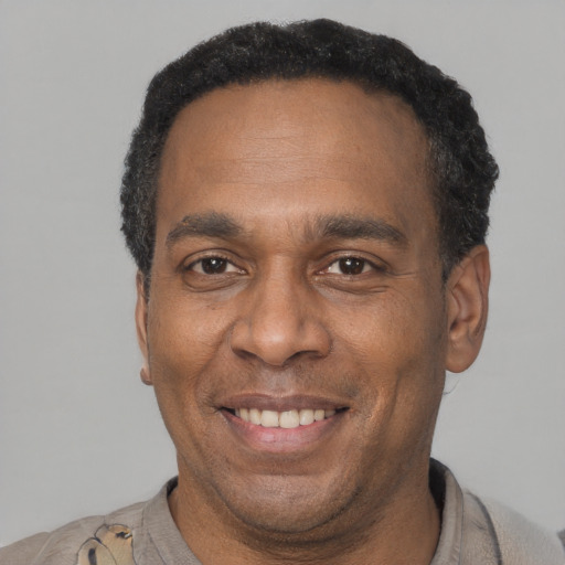 Joyful latino adult male with short  brown hair and brown eyes