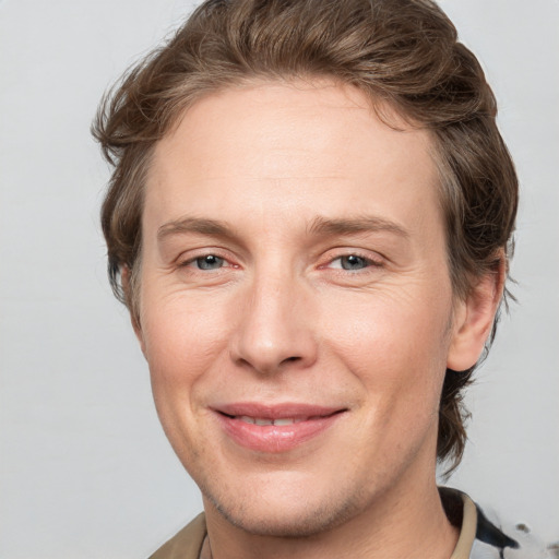 Joyful white adult male with short  brown hair and grey eyes