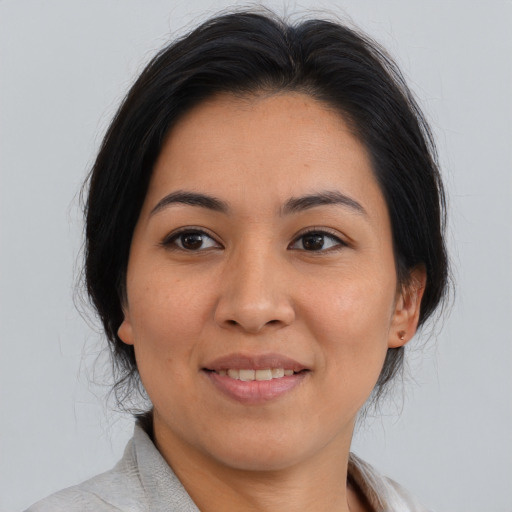 Joyful asian young-adult female with medium  brown hair and brown eyes