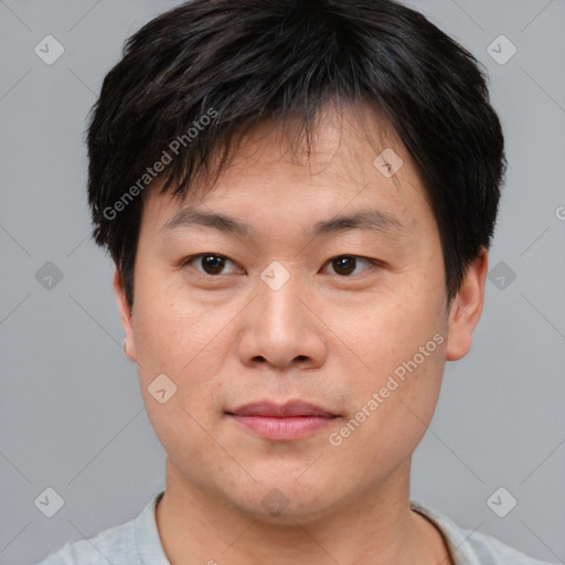 Joyful asian young-adult male with short  brown hair and brown eyes