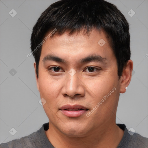 Joyful asian young-adult male with short  black hair and brown eyes