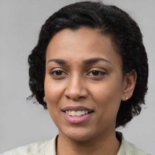 Joyful latino young-adult female with short  black hair and brown eyes