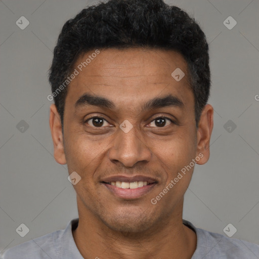 Joyful latino young-adult male with short  black hair and brown eyes