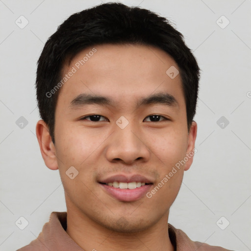 Joyful asian young-adult male with short  black hair and brown eyes