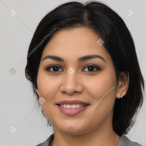 Joyful latino young-adult female with medium  brown hair and brown eyes