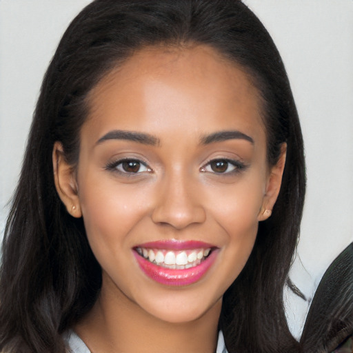 Joyful latino young-adult female with long  brown hair and brown eyes