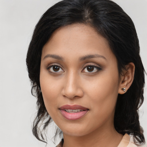 Joyful latino young-adult female with medium  brown hair and brown eyes