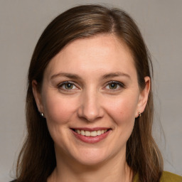 Joyful white young-adult female with long  brown hair and grey eyes