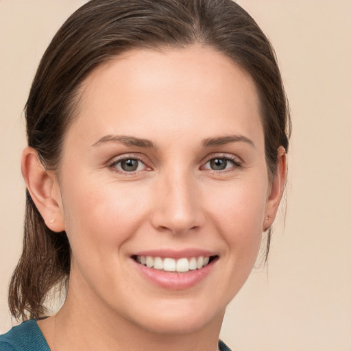 Joyful white young-adult female with medium  brown hair and grey eyes