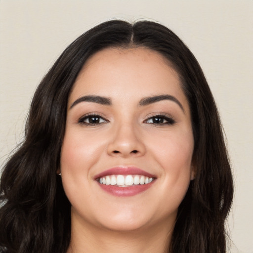 Joyful white young-adult female with long  black hair and brown eyes