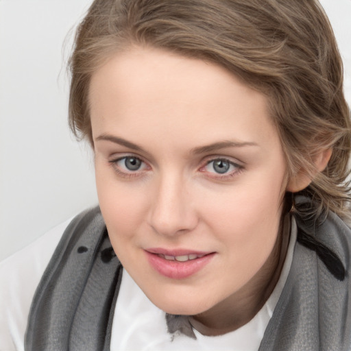 Joyful white young-adult female with medium  brown hair and blue eyes