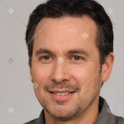 Joyful white adult male with short  brown hair and brown eyes