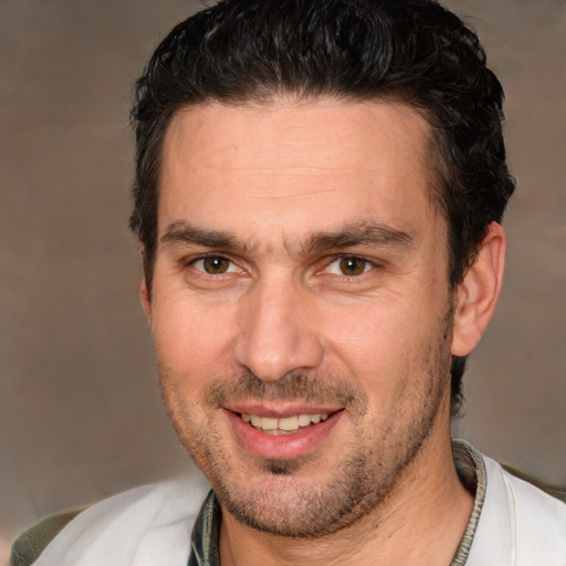 Joyful white adult male with short  brown hair and brown eyes