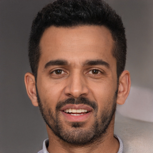 Joyful white young-adult male with short  black hair and brown eyes