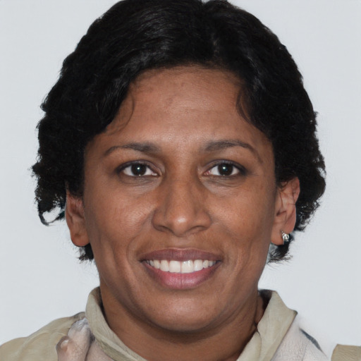 Joyful latino adult female with short  brown hair and brown eyes