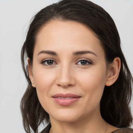 Joyful white young-adult female with medium  brown hair and brown eyes