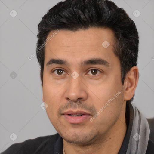 Joyful white adult male with short  black hair and brown eyes