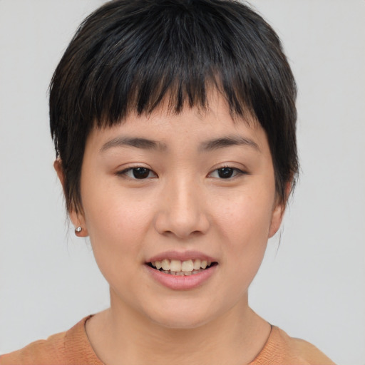 Joyful asian young-adult female with short  brown hair and brown eyes