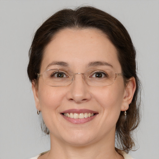 Joyful white adult female with medium  brown hair and grey eyes